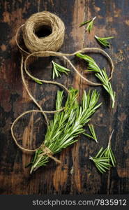 Bunch of fresh rosemary on old wooden table