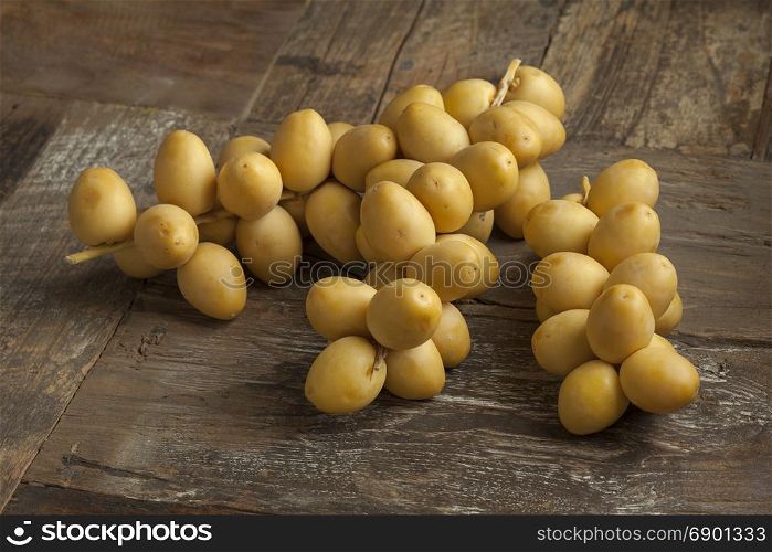 Bunch of fresh yellow dates on the table