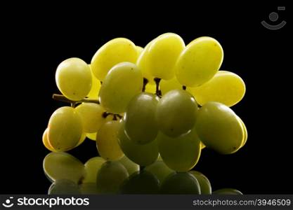 Bunch of grapes close up over black background