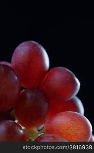 Bunch of grapes in close up with shallow depth of field. Black background