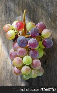 bunch of grapes on a wood surface