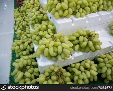 bunch of grapes on the shelves in the market