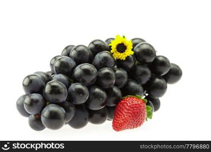 bunch of grapes with a flower and strawberries isolated on white