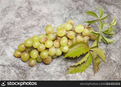 bunch of green grapes on a marble background.. bunch of green grapes on a marble background