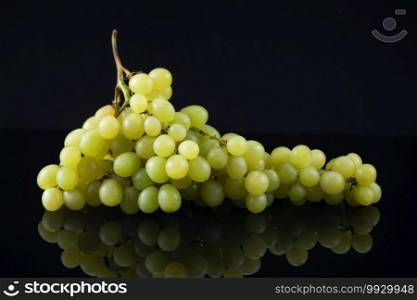 Bunch of Green Grapes on Black Background with Reflection. Green Grapes on Black Background with Reflection