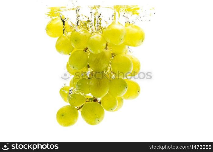 Bunch of green grapes sinking into crystal clear water with air bubbles. Isolated on a white background. Product label concept. Bunch of green grapes sinking into crystal clear water.