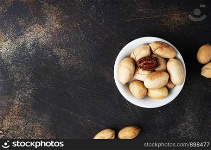 bunch of pecan nuts in white bowl