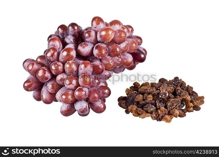 Bunch of red grapes and raisins on white background