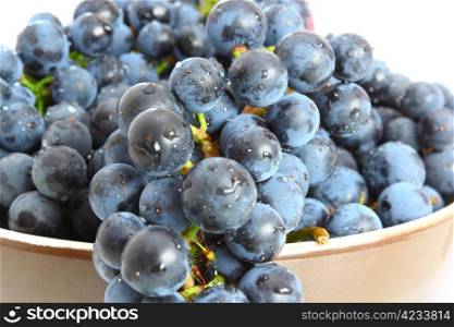 bunch of red grapes in a bowl over white