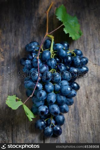 Bunch of red grapes on wooden table background