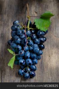 Bunch of red grapes on wooden table background