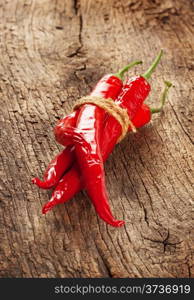 Bunch of red peppers on wooden background