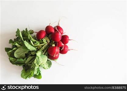 Bunch of red radish on white table. Top view