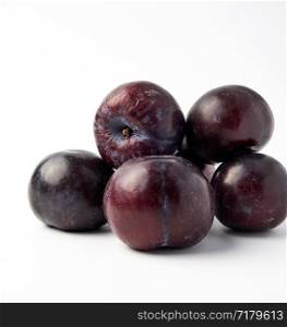 bunch of ripe fresh blue round plums on a white background, summer harvest