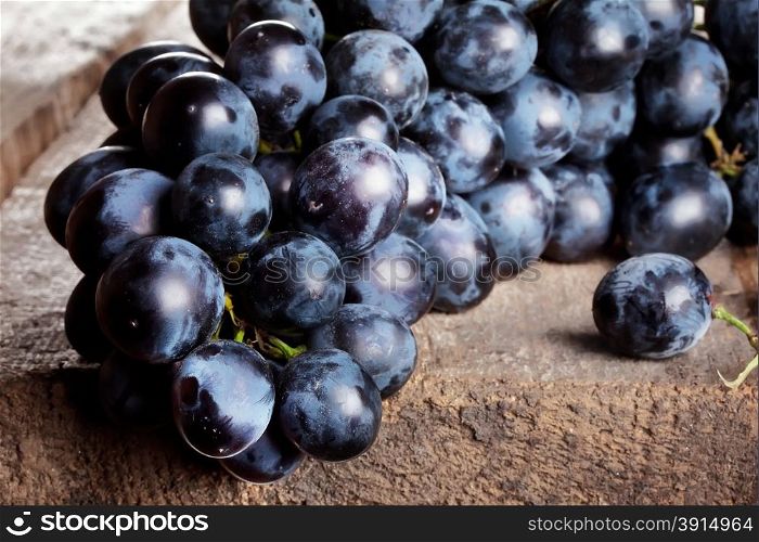 Bunch of ripe grapes on a blue wooden background