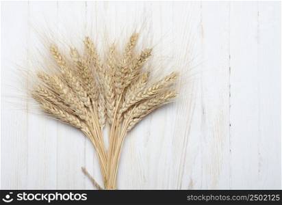 Bunch of ripe wheat on wooden table