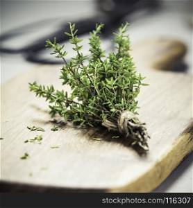 bunch of thyme and scissors on grey concrete background - Healthy food and cooking concept