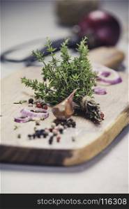 bunch of thyme, spices and scissors on grey concrete background - Healthy food and cooking concept