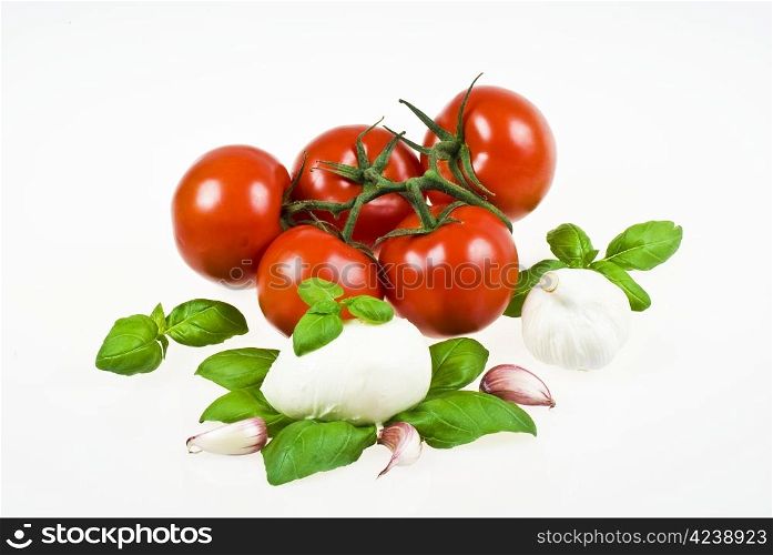 Bunch of tomatoes with mozzarella, garlic and basil