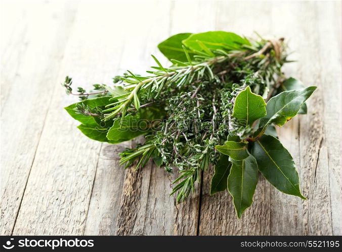 bunch of various herbs on wooden table