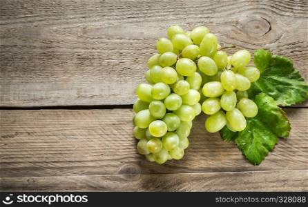 Bunch of white grape on the wooden background