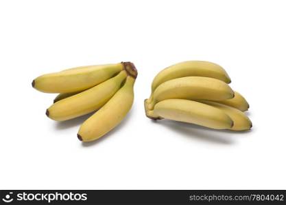 Bunches of baby bananas on white background