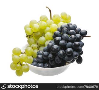 Bunches of black and green grapes in a white cup on a white background, isolated