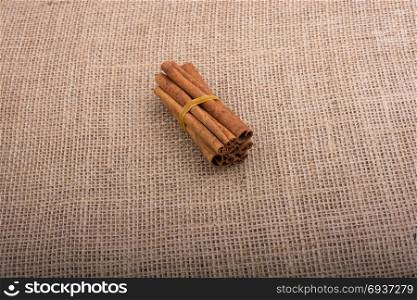 bundle of cinnamon sticks on a linen canvas background