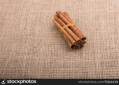 bundle of cinnamon sticks on a linen canvas  background