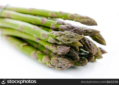 Bundle of fresh and green asparagus isolated on white background in close-up