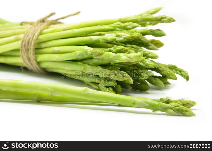 Bundle of green asparagus shoots isolated over white