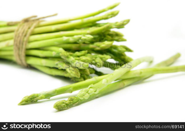 Bundle of green asparagus shoots isolated over white