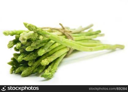 Bundle of green asparagus shoots isolated over white