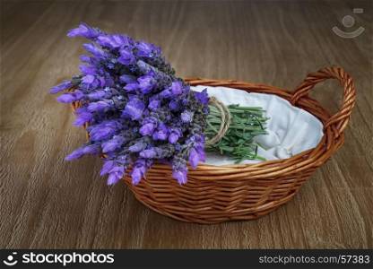 bundle of lavender flowers in wicker basket on vintage wooden table