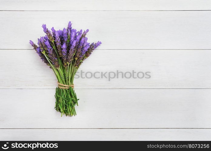 bundle of lavender flowers on on vintage wooden background