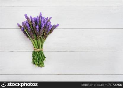 bundle of lavender flowers on on vintage wooden background