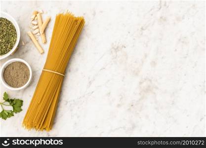 bundle uncooked spaghetti pasta ingredient marble textured background