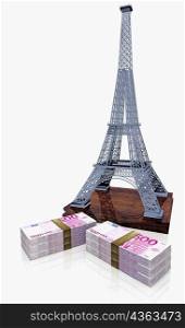 Bundles of Euro bank notes near the Eiffel tower replica