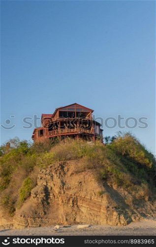 bungalow near the beach, beach restaurant on hill, concept of a house on the rock
