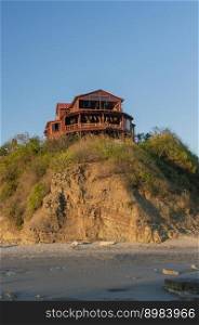 bungalow near the beach, beach restaurant on hill, concept of a house on the rock