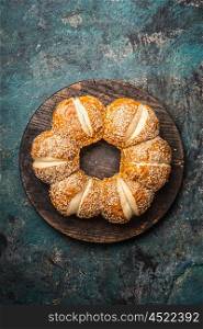 Buns with sesame on dark rustic background, top view