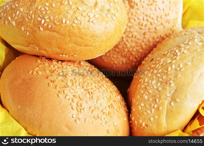 buns with sesame seeds on yellow napkin