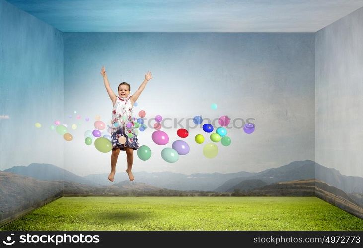 Buoyant and happy. Little cute cheerful girl in room jumping high