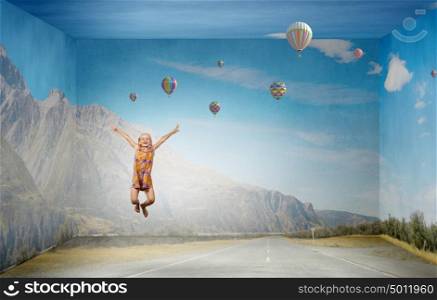 Buoyant and happy. Little cute girl jumping high and flying in sky