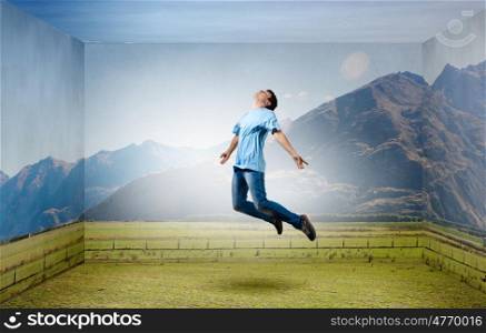 Buoyant and happy. Young man jumping in sky in 3d room