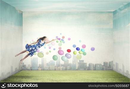 Buoyant and happy. Young woman in summer dress flying in sky