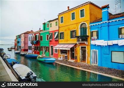 BURANO, ITALY - NOVEMBER 23: Brightly painted houses at the Burano canal on November 23, 2015 in Burano, Venice, Italy. It&rsquo;s an island in the Venetian Lagoon, northern Italy.