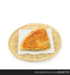 Burek or pie with apples on a paper serviette in a wicker or bread basket over white background