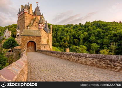 Burg Eltz castle in Rhineland-Palatinate state at sunset, Germany. Construction started prior to 1157.