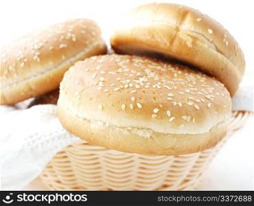 Burger buns. Hamburger buns in wooden basket, with a white towle towards white